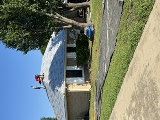 Crew installing roof underlayment